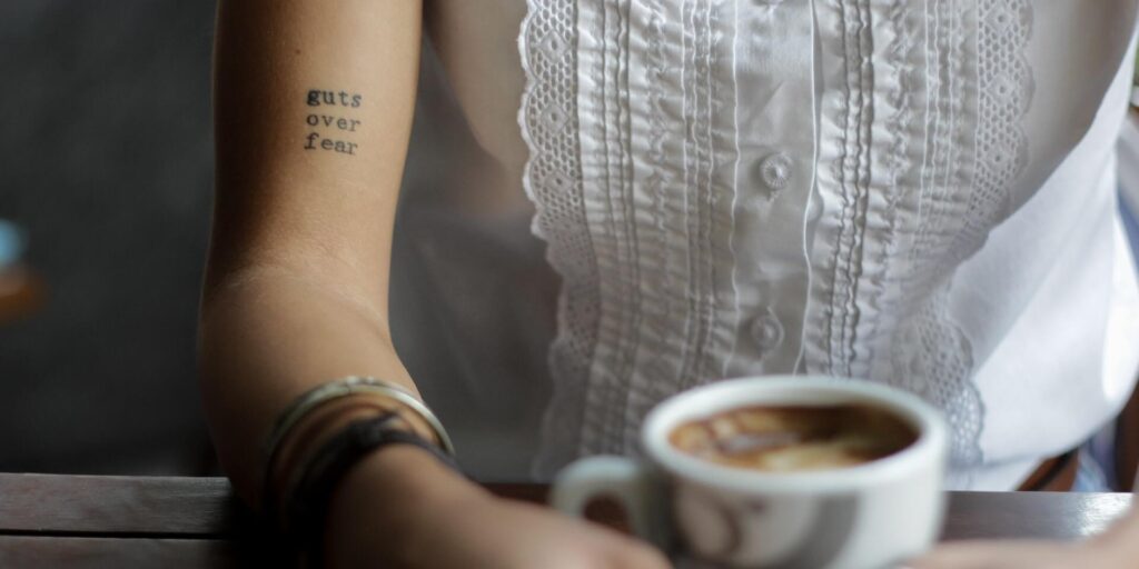 fear-of-writing-person-holding-mug-tattoo-guts-over-fear